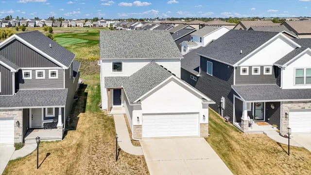 an aerial view of a house with a yard