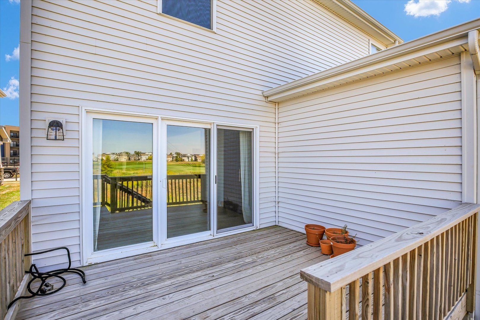4508 Legends Drive Champaign, IL 61822 - Photo 36 of 45 a view of a deck with wooden floor and a potted plant