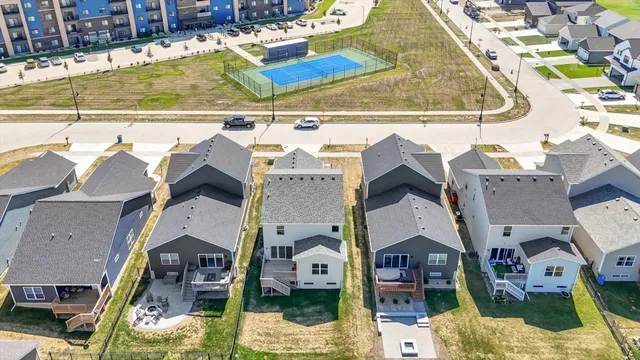 a view of houses with a big yard