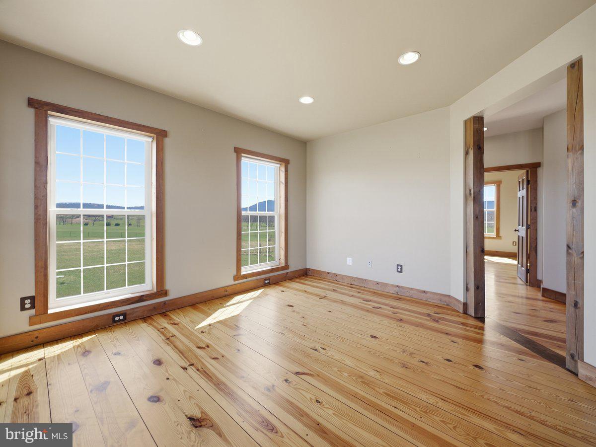 9763 Blue Spring Road Mercersburg, PA 17236 - Photo 13 of 85 a view of an empty room with wooden floor and a window