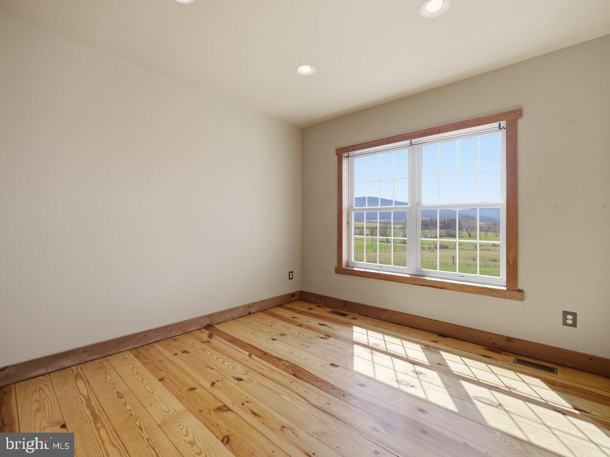 9763 Blue Spring Road Mercersburg, PA 17236 - Photo 15 of 85 a view of an empty room with wooden floor and a window
