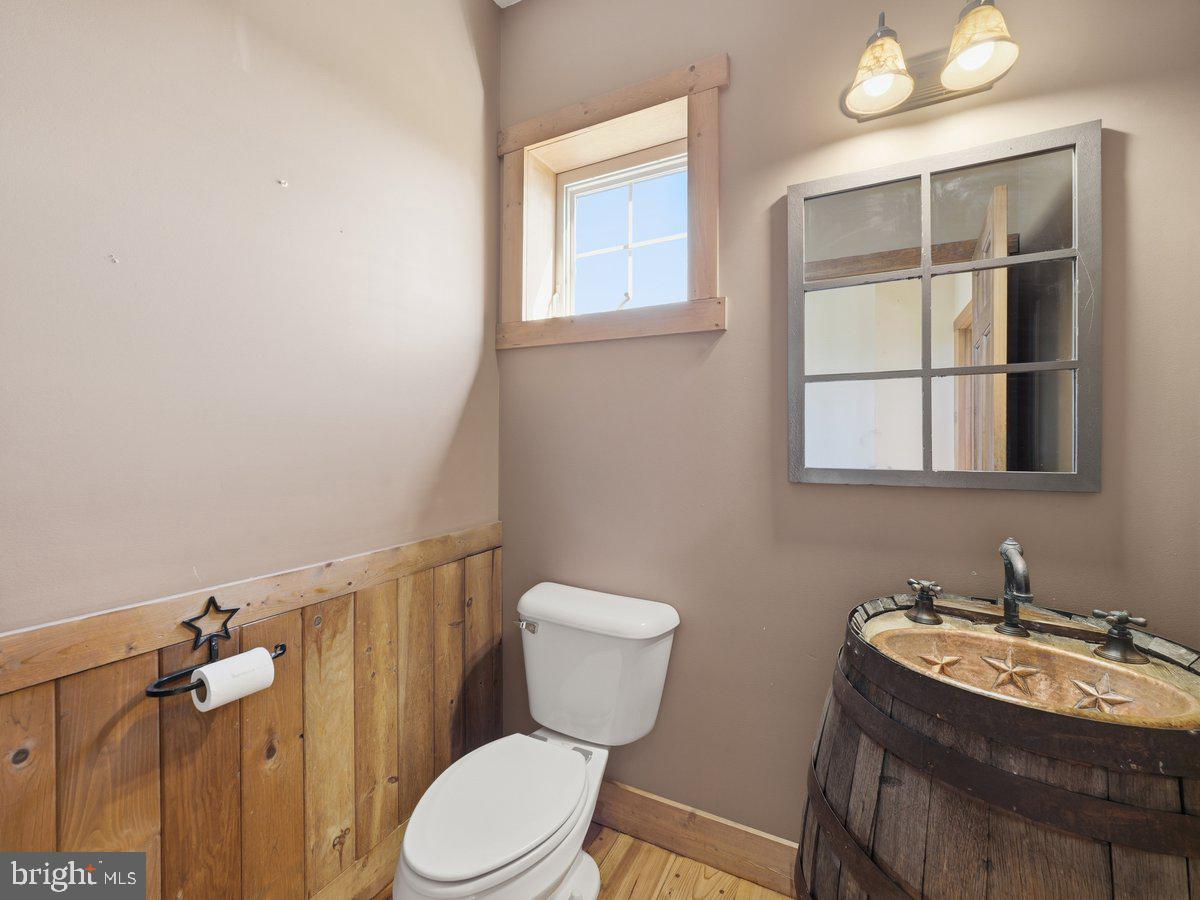 9763 Blue Spring Road Mercersburg, PA 17236 - Photo 17 of 85 a bathroom with a toilet sink and mirror