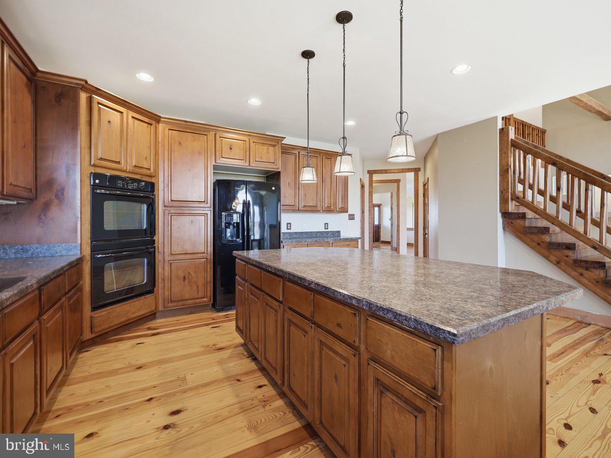 9763 Blue Spring Road Mercersburg, PA 17236 - Photo 19 of 85 a kitchen with stainless steel appliances granite countertop a sink a oven and a refrigerator
