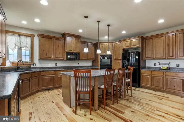 a en suite bathroom with a granite countertop sink and a mirror