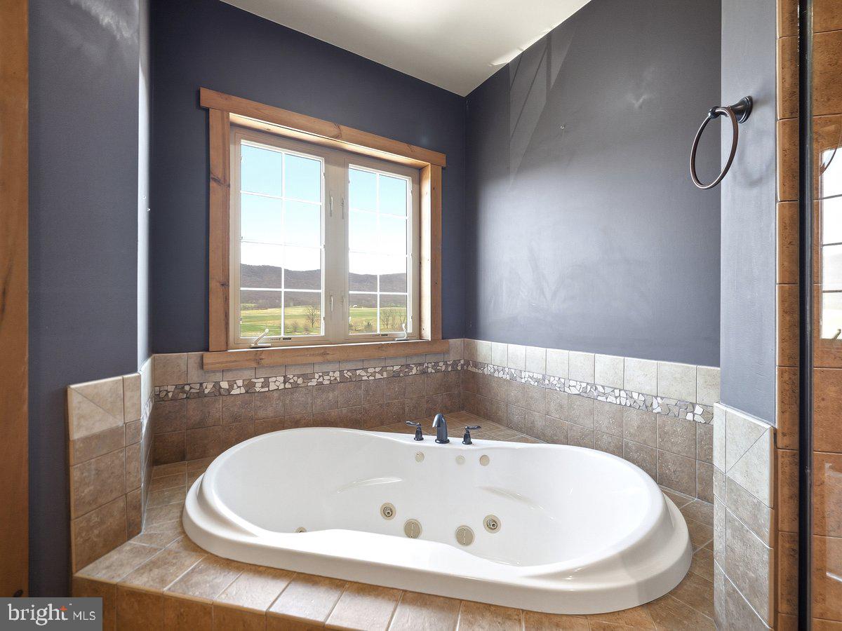9763 Blue Spring Road Mercersburg, PA 17236 - Photo 37 of 85 a bathroom with a bathtub and window