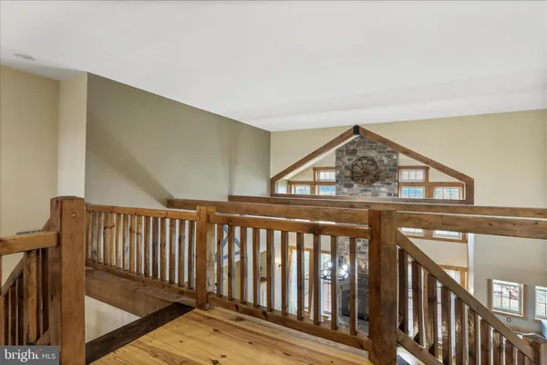 a view of a balcony with wooden floor space and mountain view