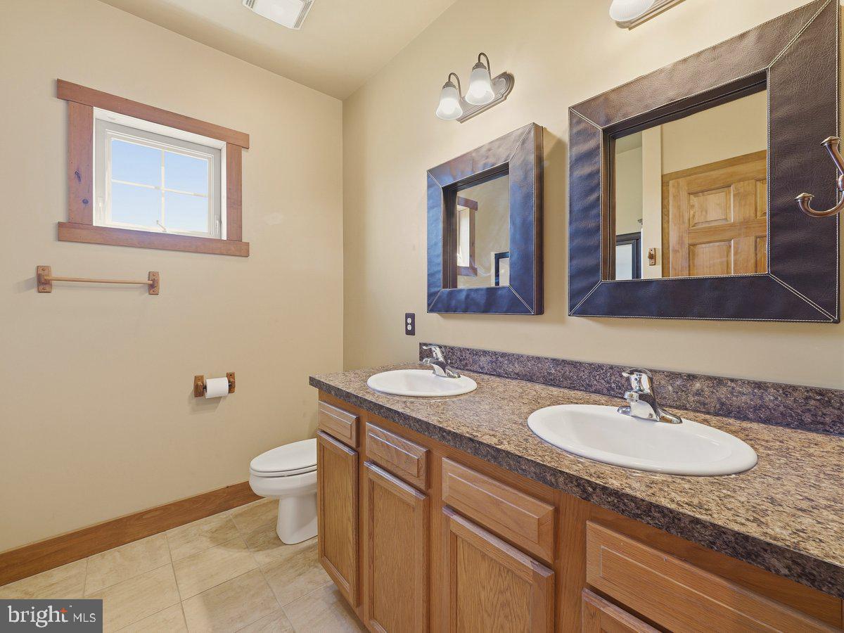 9763 Blue Spring Road Mercersburg, PA 17236 - Photo 48 of 85 a bathroom with a granite countertop sink and a mirror