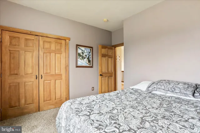 a view of a house with a big yard and large trees