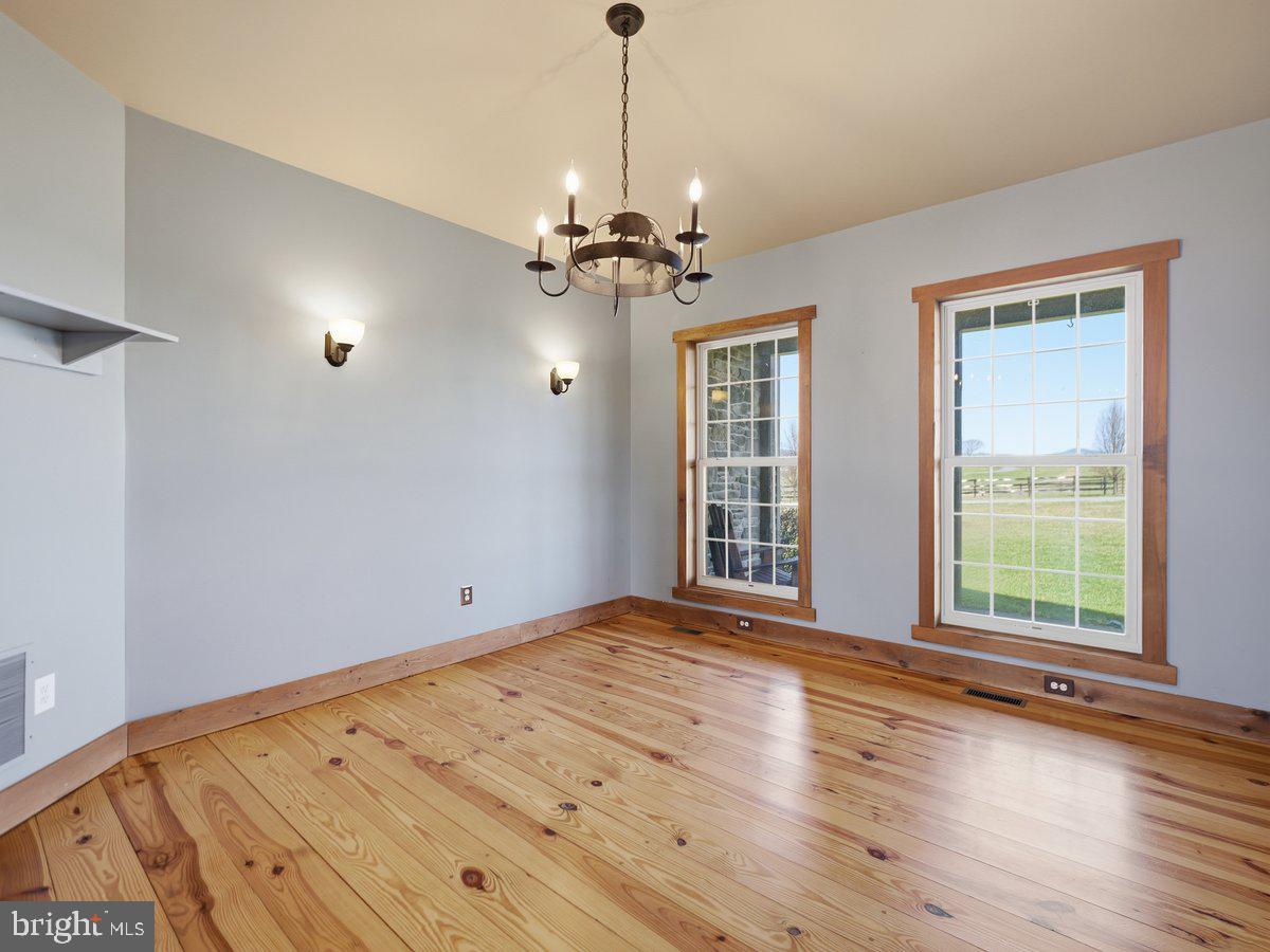 9763 Blue Spring Road Mercersburg, PA 17236 - Photo 9 of 85 a view of an empty room with a window and wooden floor
