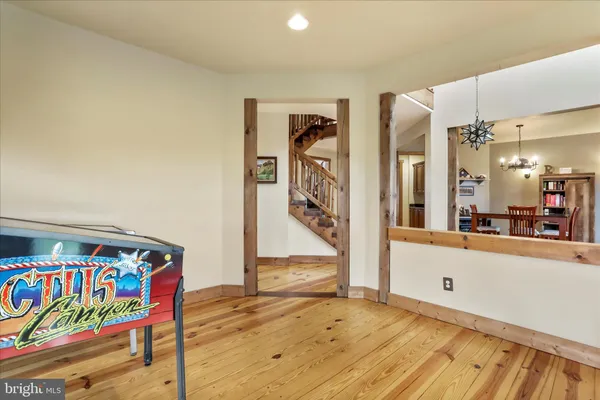 a view of a hallway with wooden floor and staircase