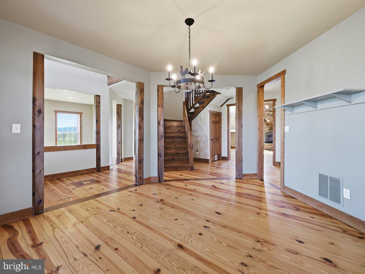 9763 Blue Spring Road Mercersburg, PA 17236 - Photo 10 of 85 a view of a room with wooden floor ceiling fan and windows