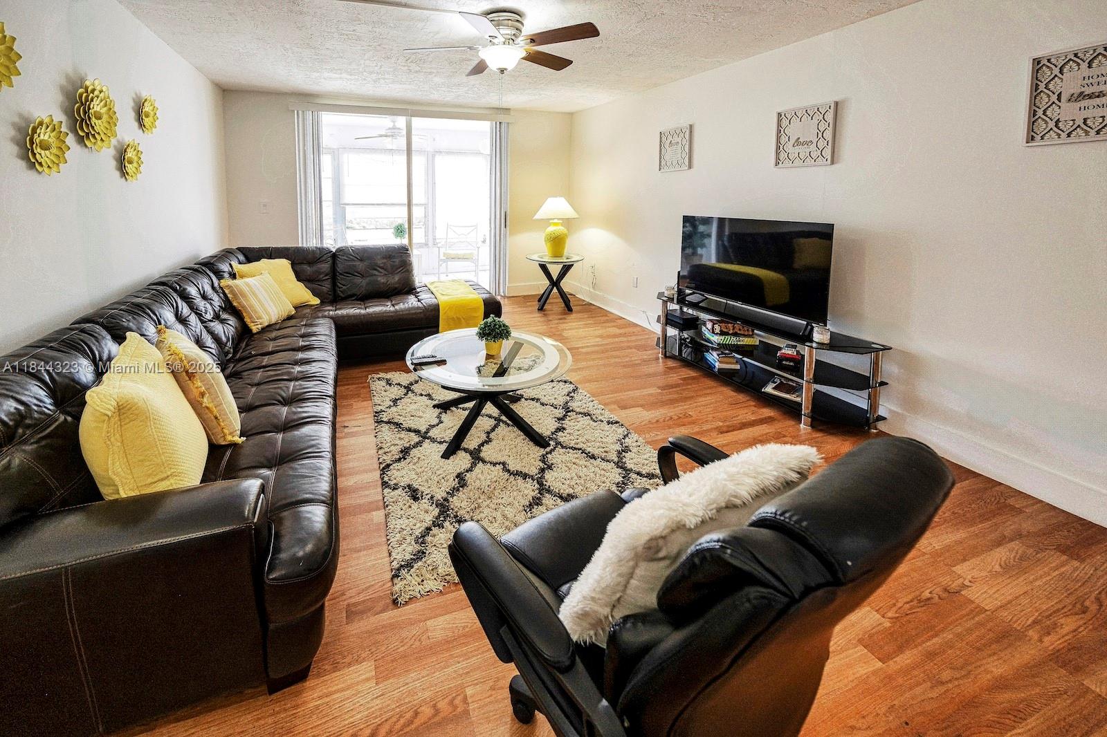 7300 Northwest 17th Street, Unit 415 Plantation, FL 33313 - Photo 1 of 19 a living room with furniture and a flat screen tv