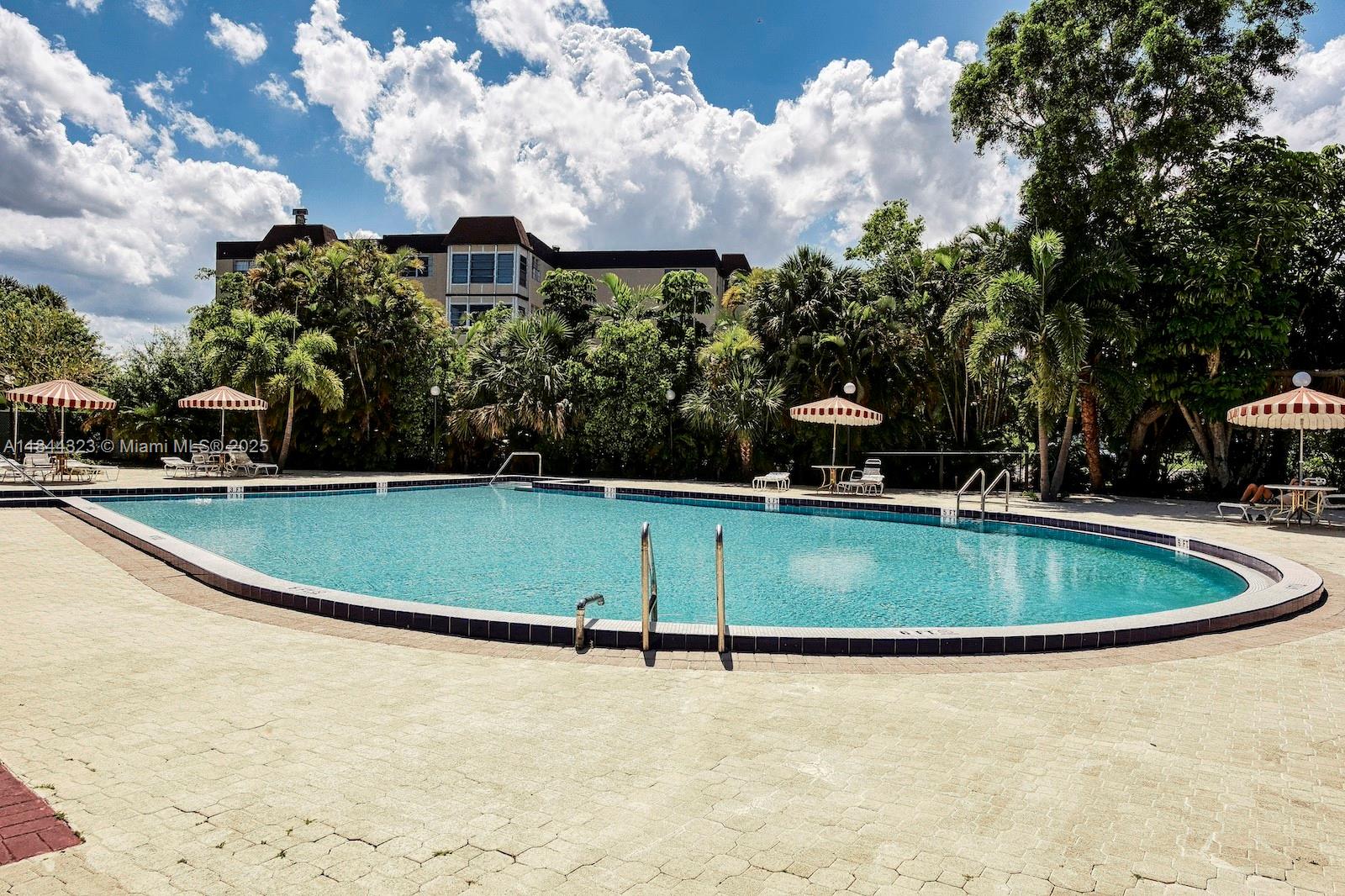 7300 Northwest 17th Street, Unit 415 Plantation, FL 33313 - Photo 17 of 19 a view of outdoor space and swimming pool
