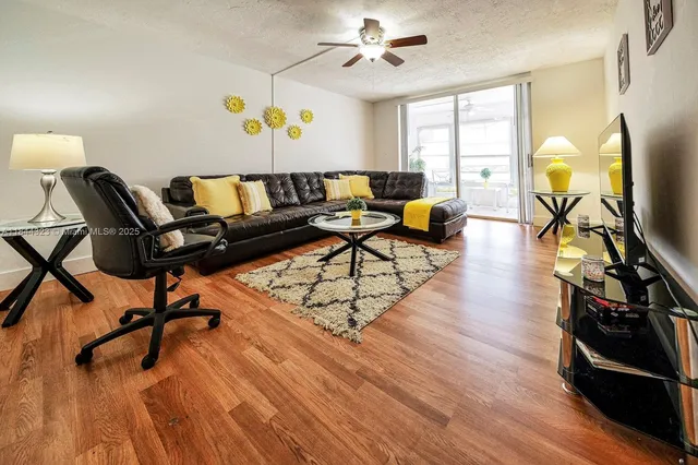 a living room with furniture and a wooden floor
