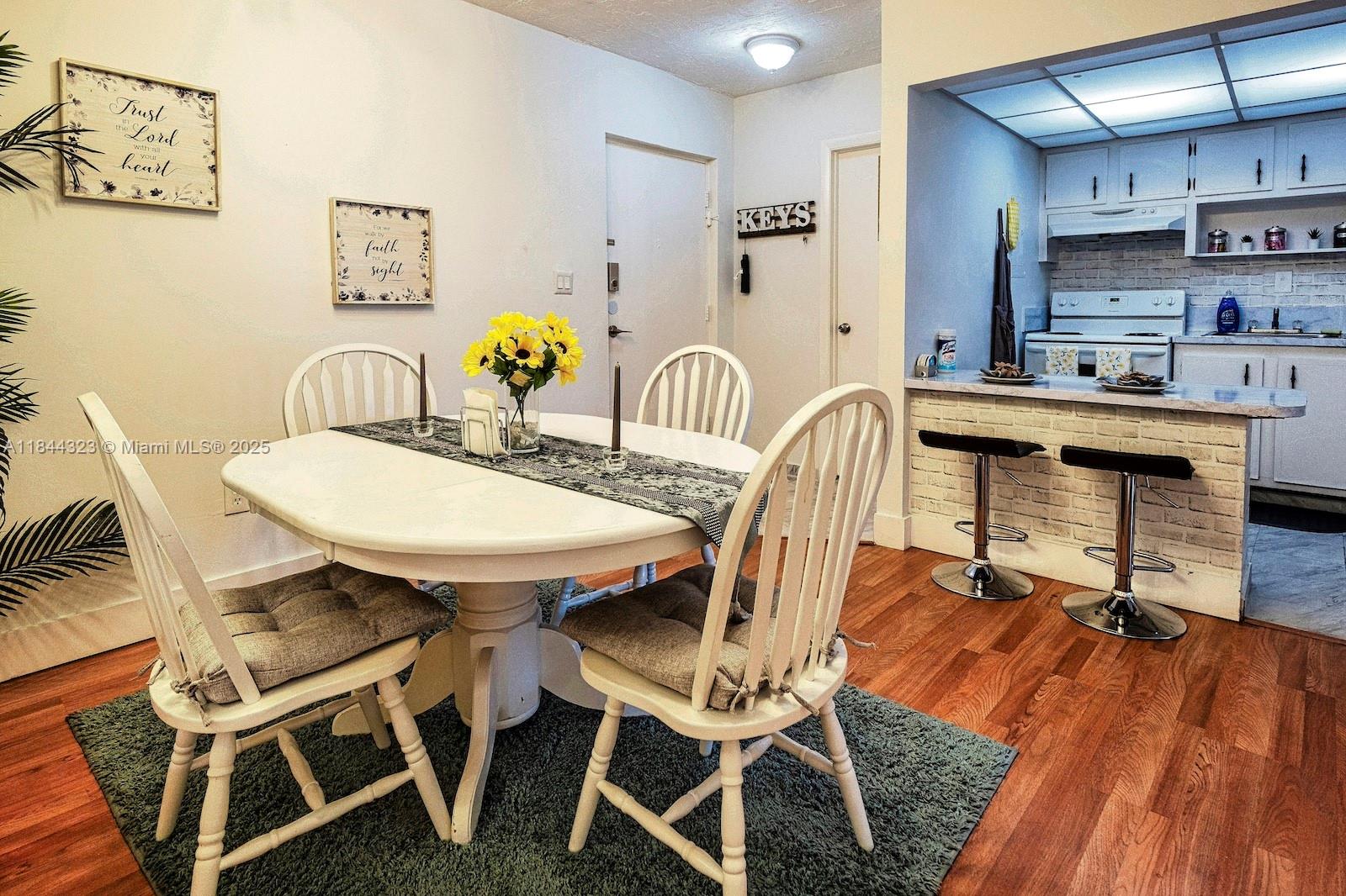 7300 Northwest 17th Street, Unit 415 Plantation, FL 33313 - Photo 6 of 19 a view of a dining room with furniture and wooden floor