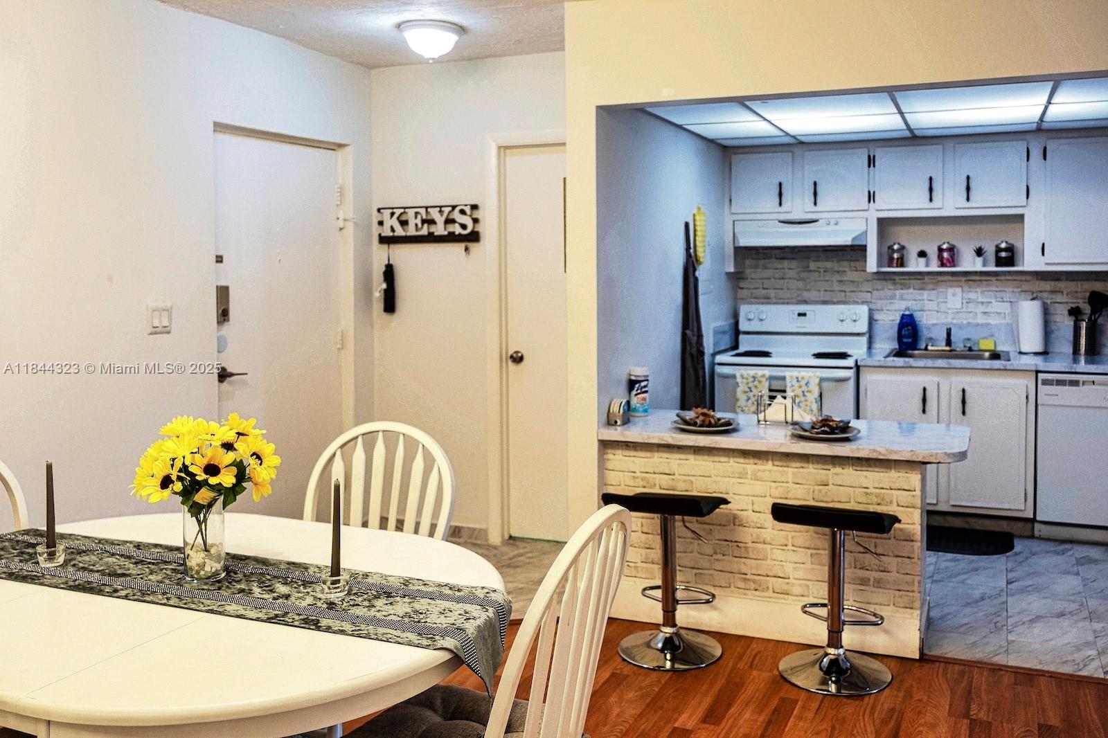 7300 Northwest 17th Street, Unit 415 Plantation, FL 33313 - Photo 7 of 19 a view of a dining room with furniture and wooden floor