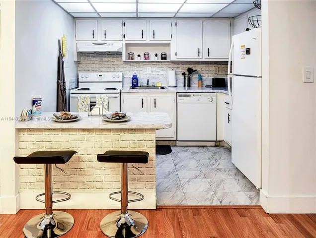a kitchen with stainless steel appliances granite countertop a sink and cabinets