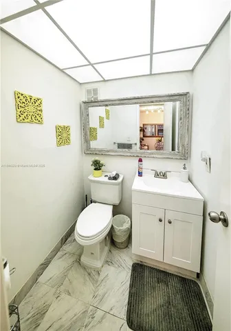 a bathroom with a sink toilet and window