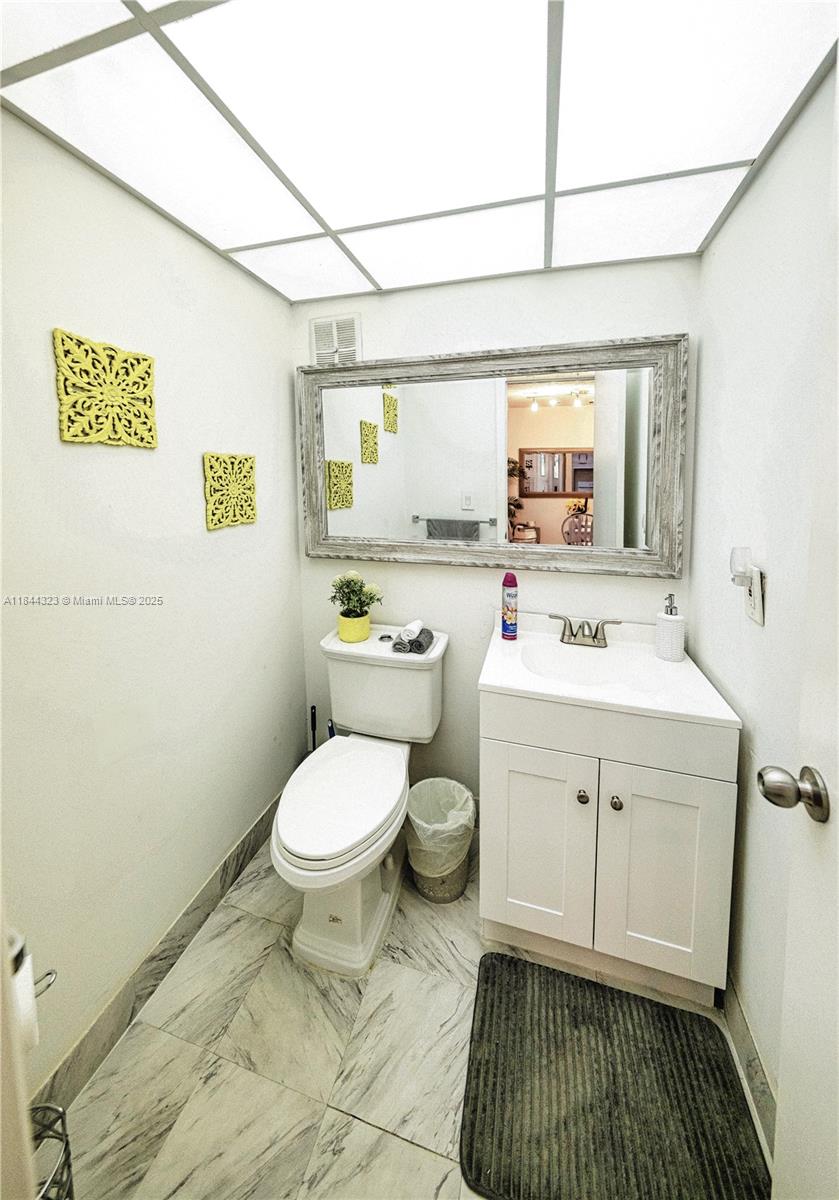 7300 Northwest 17th Street, Unit 415 Plantation, FL 33313 - Photo 10 of 19 a bathroom with a sink toilet and window