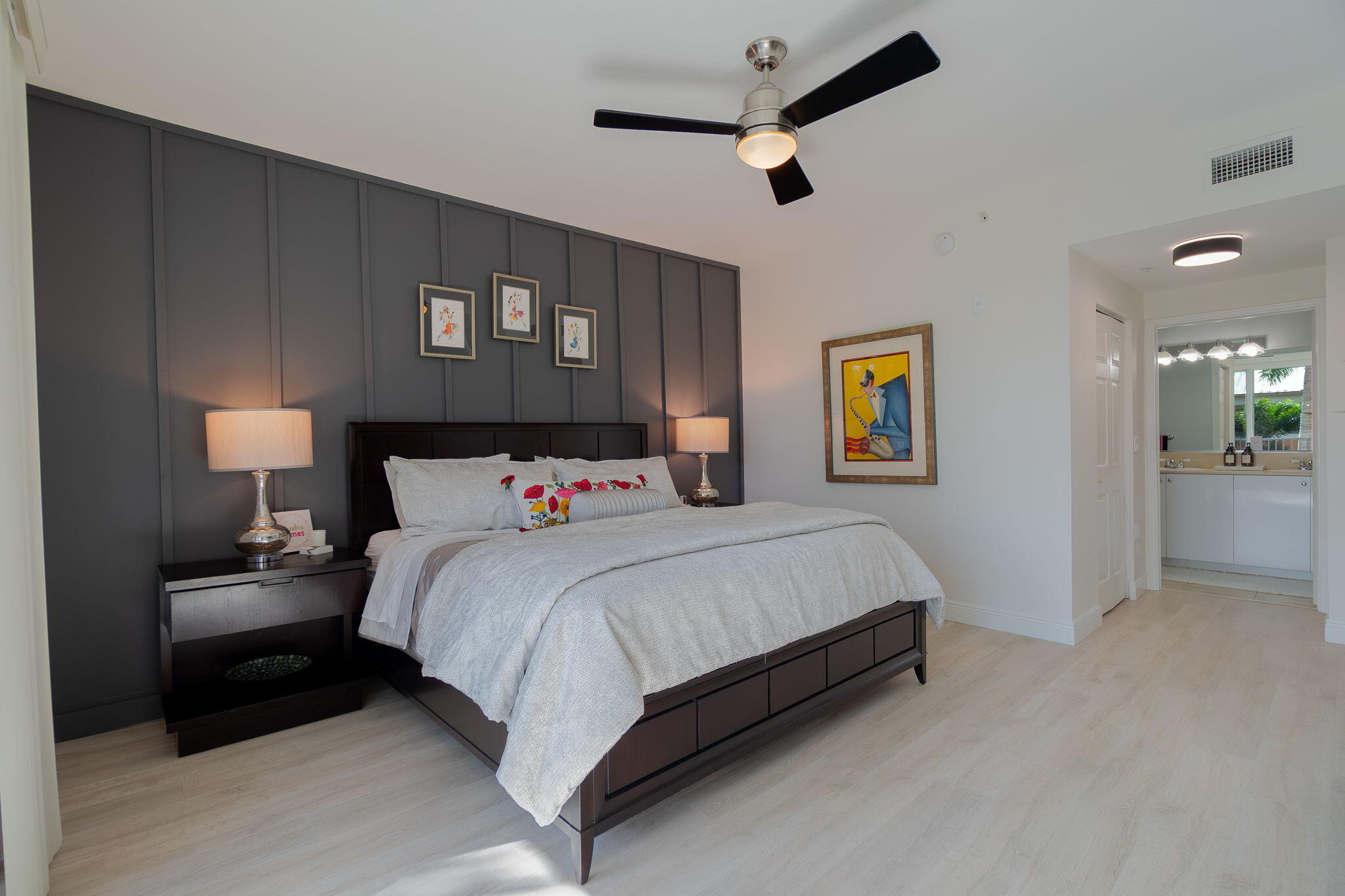 804 East Windward Way, Unit 307 Lantana, FL 33462 - Photo 14 of 44 a bedroom with a bed and a lamp on dresser