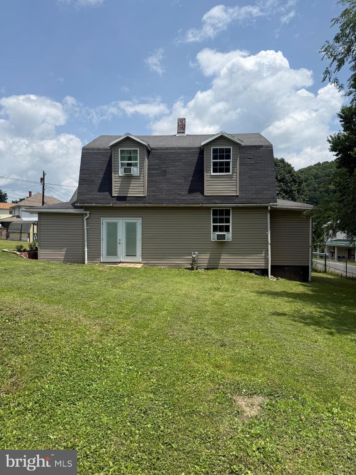 23708 Legislative Road Southwest Barton, MD 21521 - Photo 22 of 24 a front view of a house with a garden