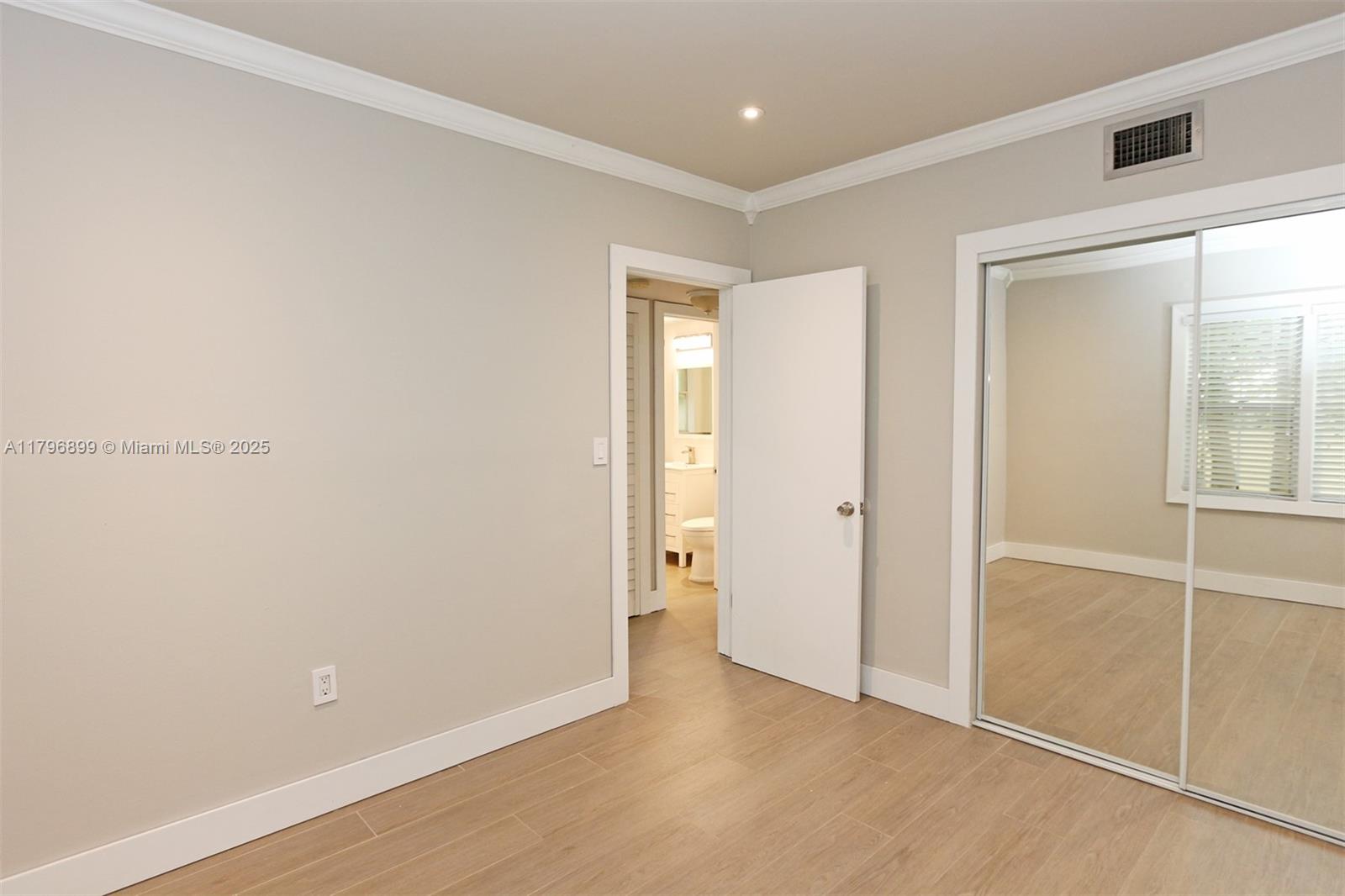 3375 Franklin Avenue, Unit D Miami, FL 33133 - Photo 17 of 33 an empty room with closet and mirror