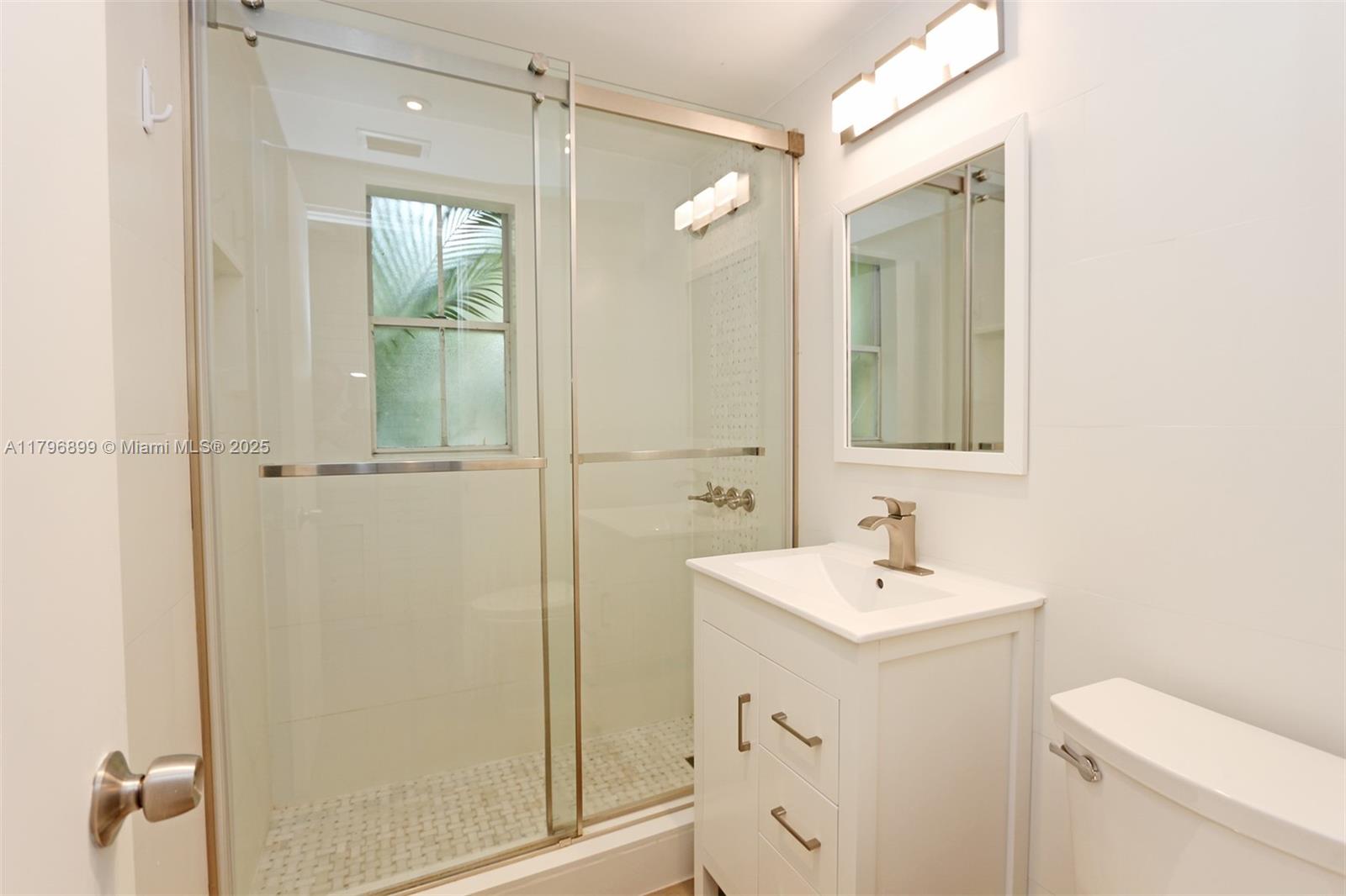 3375 Franklin Avenue, Unit D Miami, FL 33133 - Photo 19 of 33 a bathroom with a sink a toilet and shower