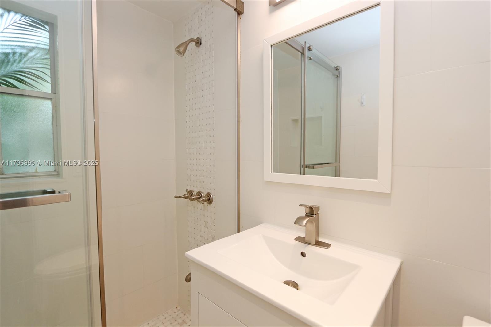 3375 Franklin Avenue, Unit D Miami, FL 33133 - Photo 22 of 33 a bathroom with a sink and a mirror