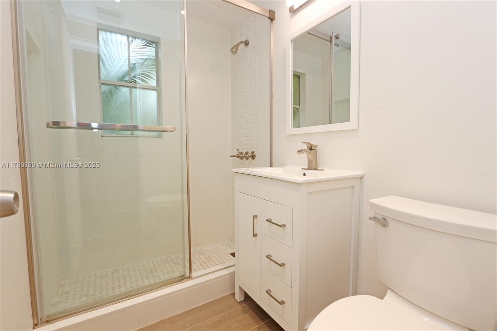 3375 Franklin Avenue, Unit D Miami, FL 33133 - Photo 23 of 33 a bathroom with a sink a toilet and shower