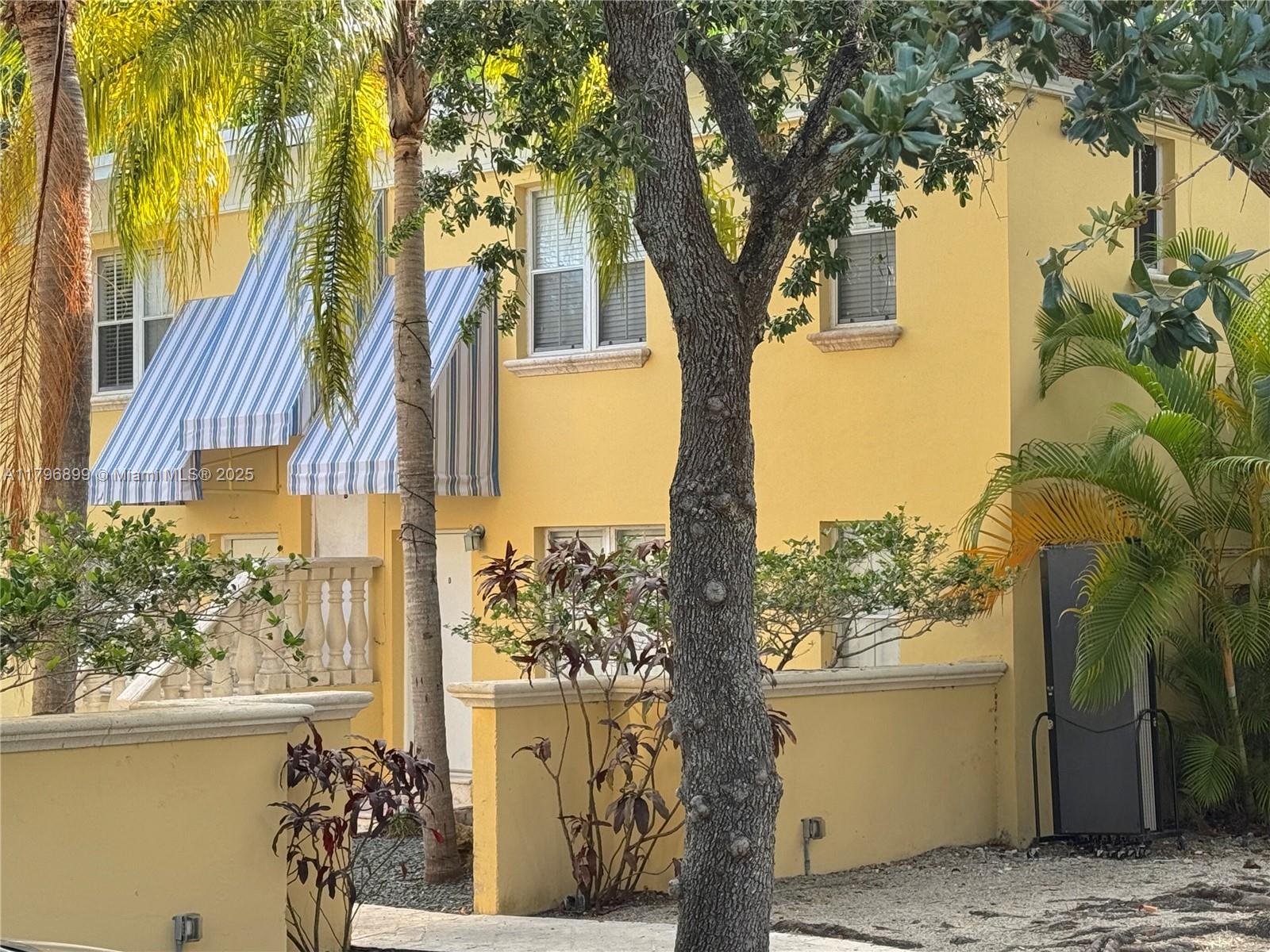 3375 Franklin Avenue, Unit D Miami, FL 33133 - Photo 29 of 33 a view of a house with a tree in the background