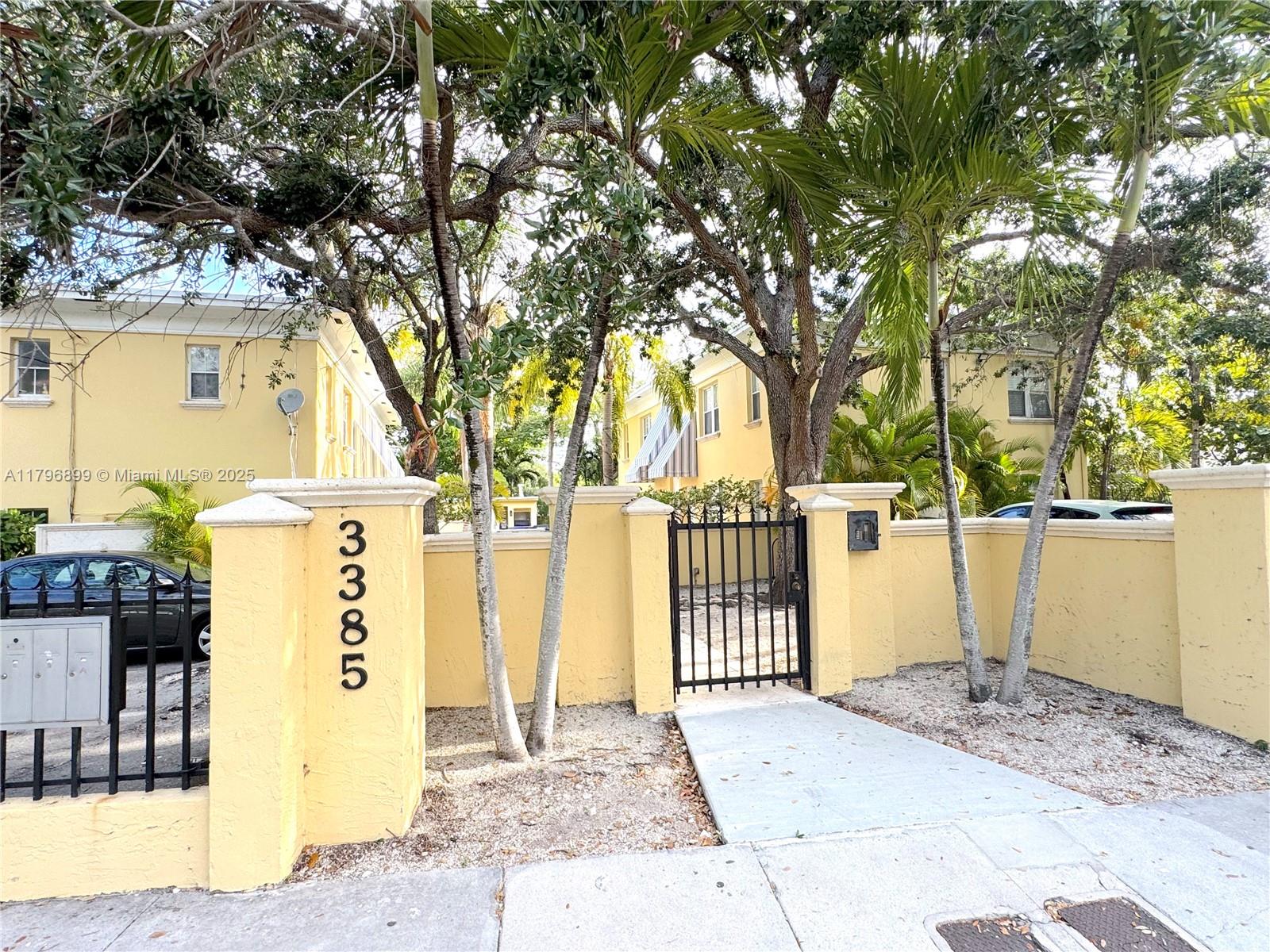 3375 Franklin Avenue, Unit D Miami, FL 33133 - Photo 33 of 33 a view of entrance gate of a house with wooden fence