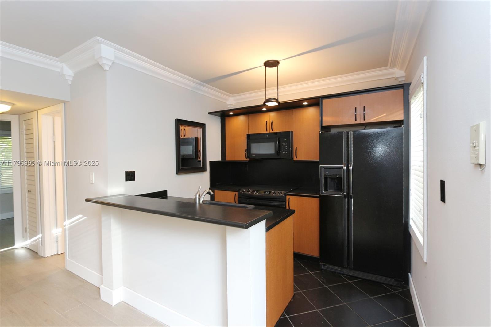 3375 Franklin Avenue, Unit D Miami, FL 33133 - Photo 5 of 33 a kitchen with stainless steel appliances a sink and a refrigerator