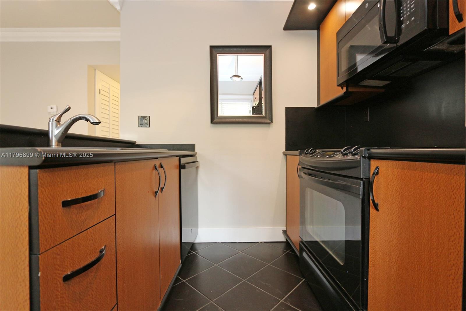 3375 Franklin Avenue, Unit D Miami, FL 33133 - Photo 6 of 33 a kitchen with granite countertop a sink stove and cabinets