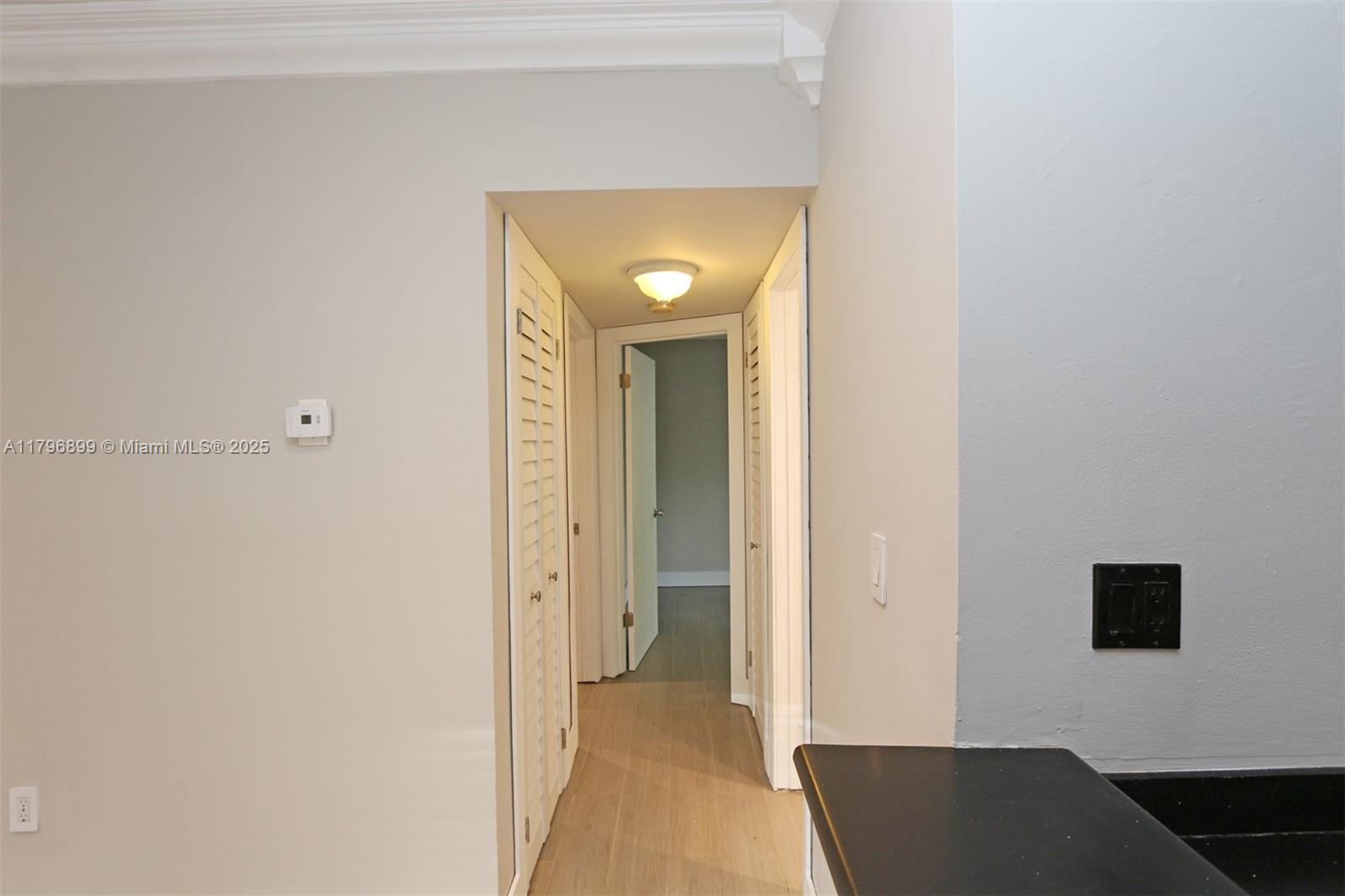 3375 Franklin Avenue, Unit D Miami, FL 33133 - Photo 8 of 33 a view of a hallway with wooden floor and a bathroom