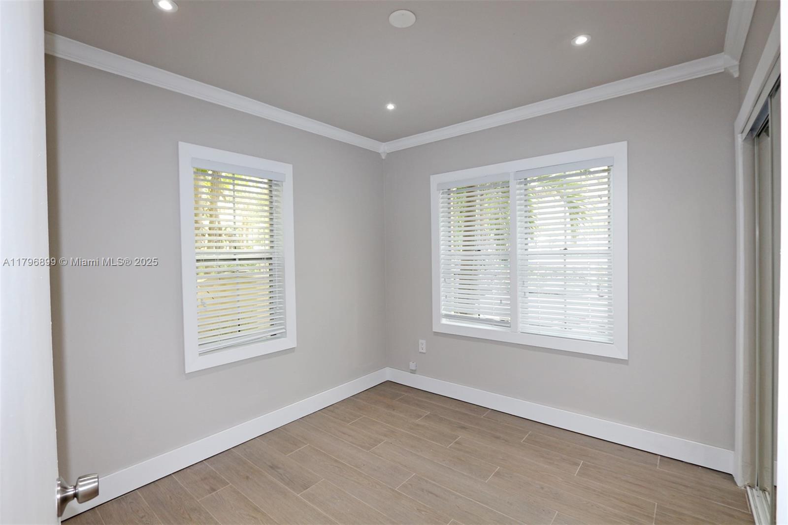 3375 Franklin Avenue, Unit D Miami, FL 33133 - Photo 10 of 33 an empty room with wooden floor and windows