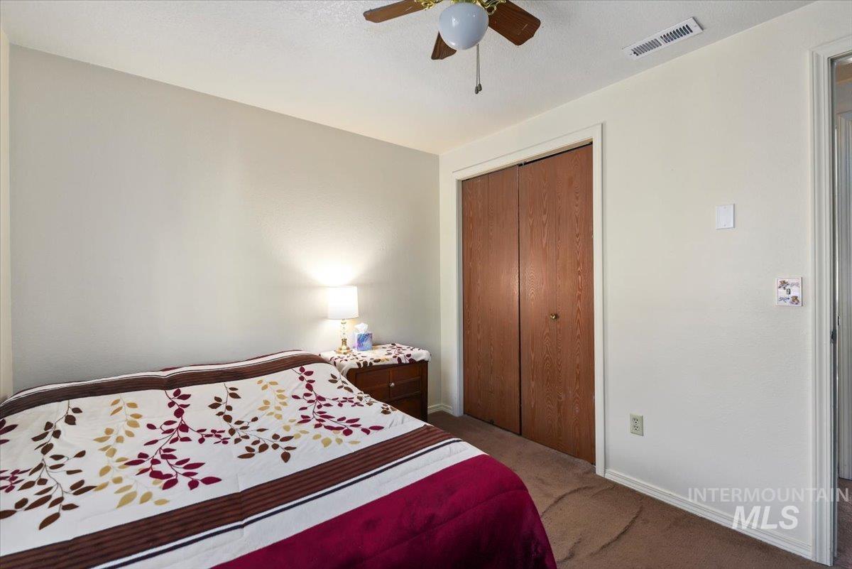 2811 Apollo Place Caldwell, ID 83605 - Photo 12 of 31 Bedroom with a closet, a ceiling fan, and light carpet