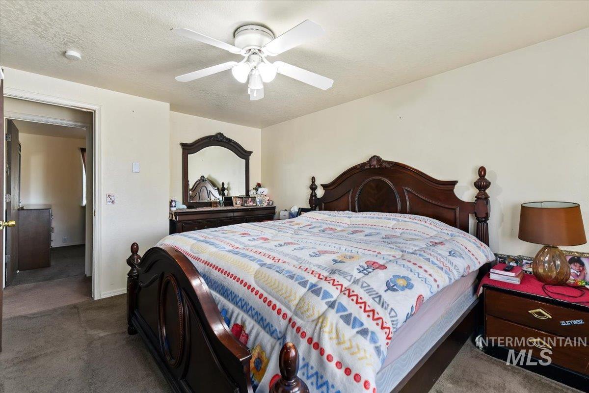 2811 Apollo Place Caldwell, ID 83605 - Photo 14 of 31 Carpeted bedroom featuring ceiling fan and a textured ceiling