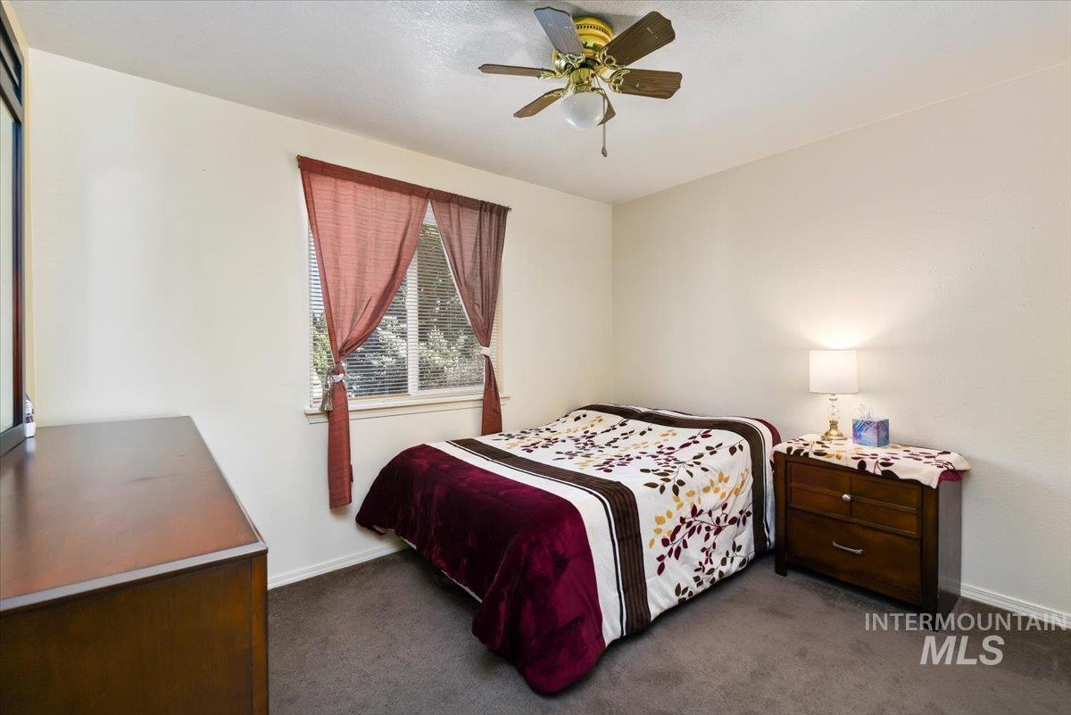 2811 Apollo Place Caldwell, ID 83605 - Photo 15 of 31 Bedroom featuring dark colored carpet and a ceiling fan