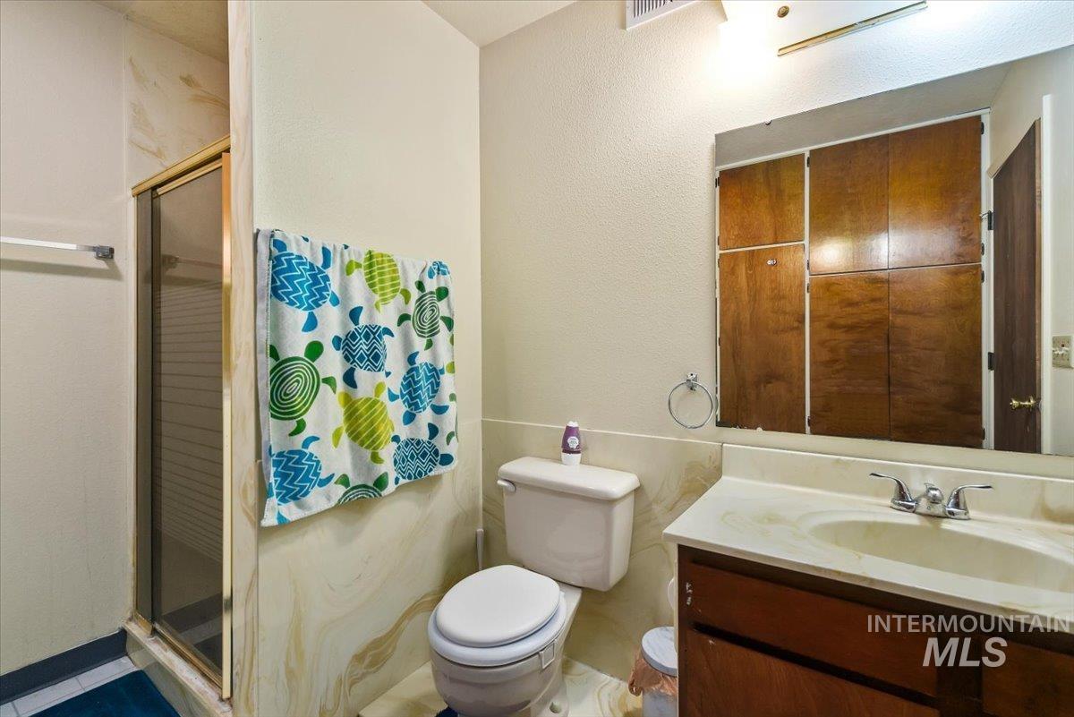 2811 Apollo Place Caldwell, ID 83605 - Photo 19 of 31 Full bath featuring a stall shower, vanity, and a textured wall