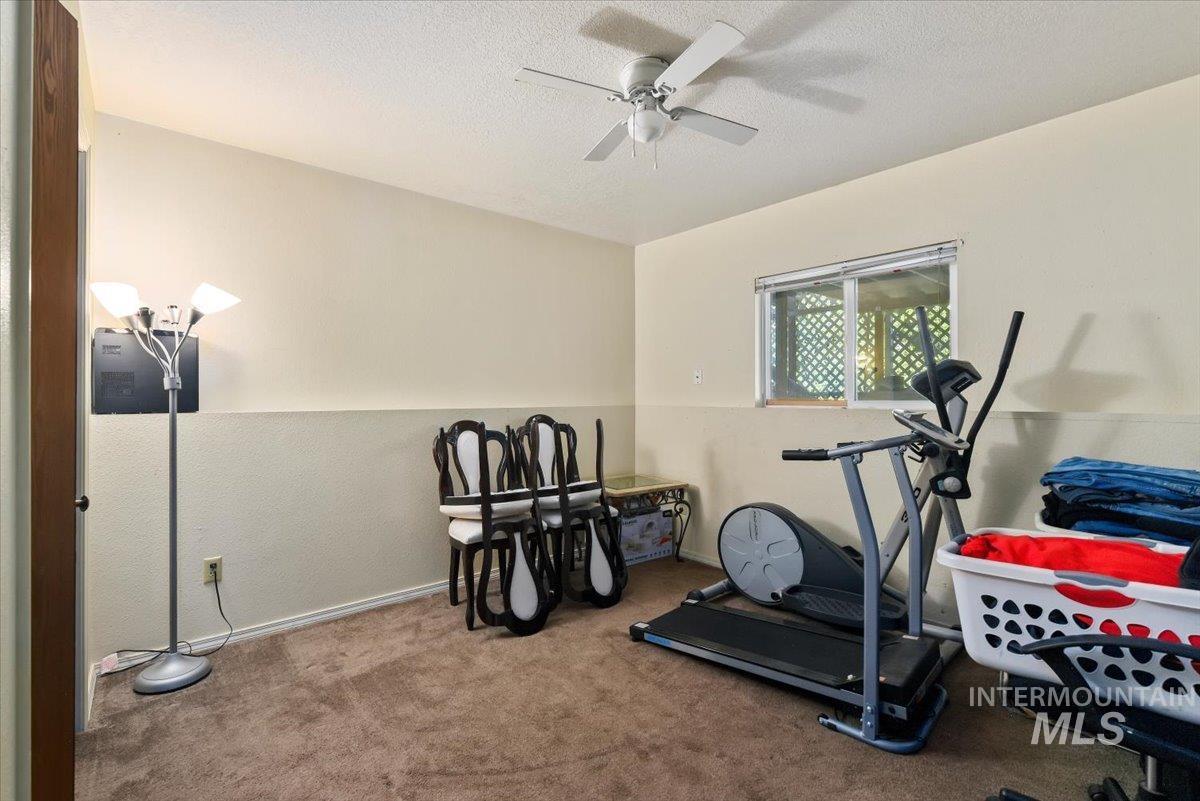 2811 Apollo Place Caldwell, ID 83605 - Photo 21 of 31 Workout area with a textured ceiling, carpet floors, and ceiling fan