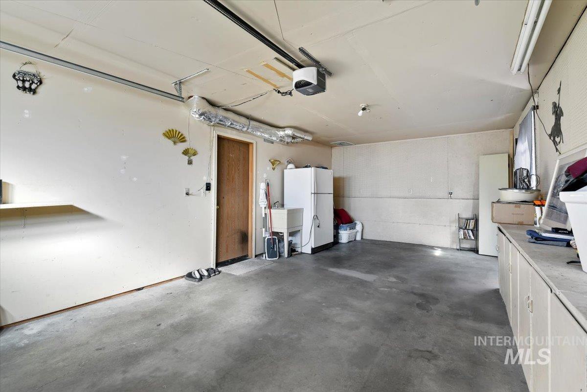 2811 Apollo Place Caldwell, ID 83605 - Photo 24 of 31 Garage featuring freestanding refrigerator and a garage door opener