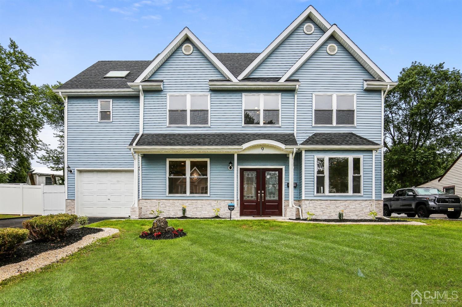 9 Markham Road Edison, NJ 08817 - Photo 1 of 28 a front view of a house with a garden