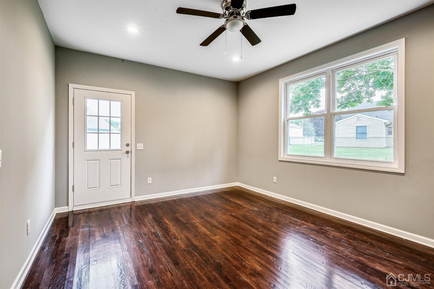 9 Markham Road Edison, NJ 08817 - Photo 14 of 28 wooden floor in an empty room with a window