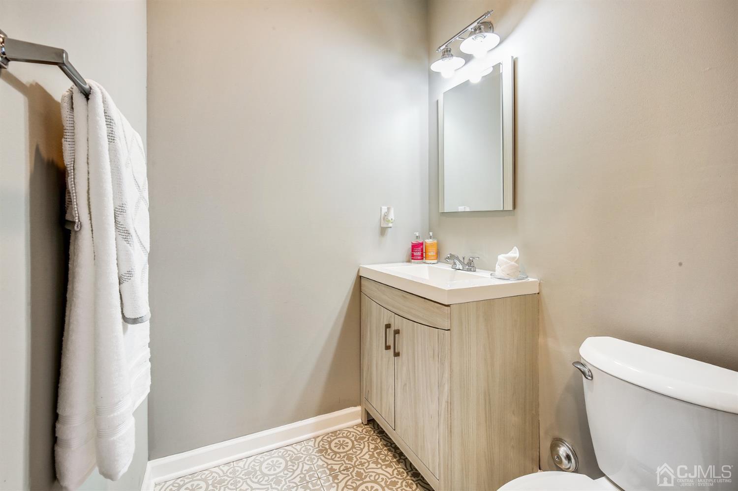 9 Markham Road Edison, NJ 08817 - Photo 15 of 28 a bathroom with a sink vanity mirror and toilet