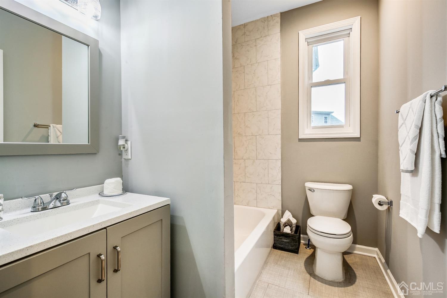 9 Markham Road Edison, NJ 08817 - Photo 16 of 28 a bathroom with a toilet sink and mirror