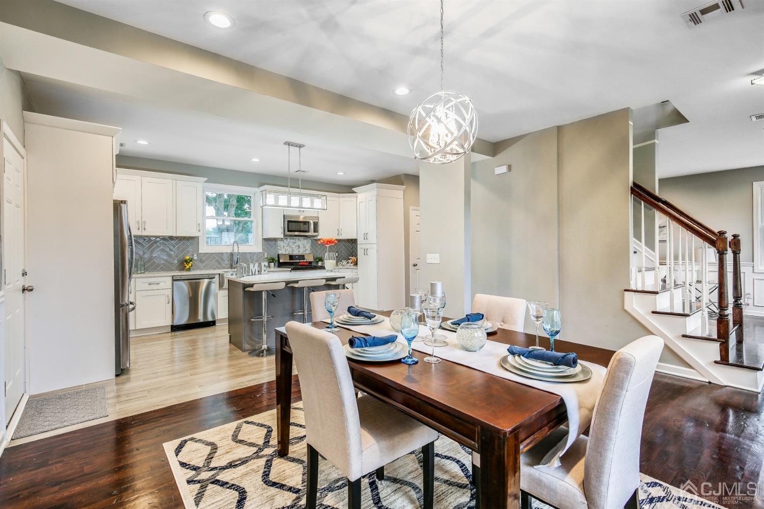 9 Markham Road Edison, NJ 08817 - Photo 17 of 28 a view of a dining room with furniture a kitchen and chandelier