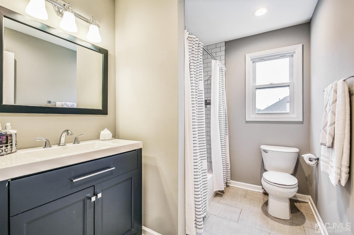 9 Markham Road Edison, NJ 08817 - Photo 20 of 28 a bathroom with a toilet sink and mirror