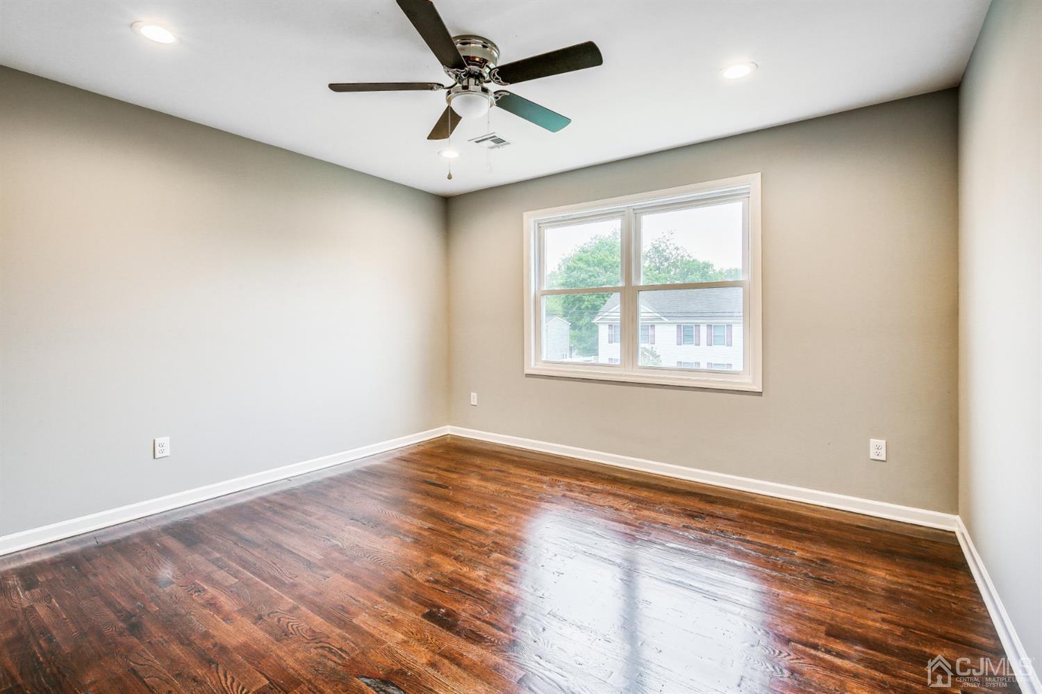 9 Markham Road Edison, NJ 08817 - Photo 21 of 28 an empty room with wooden floor and windows