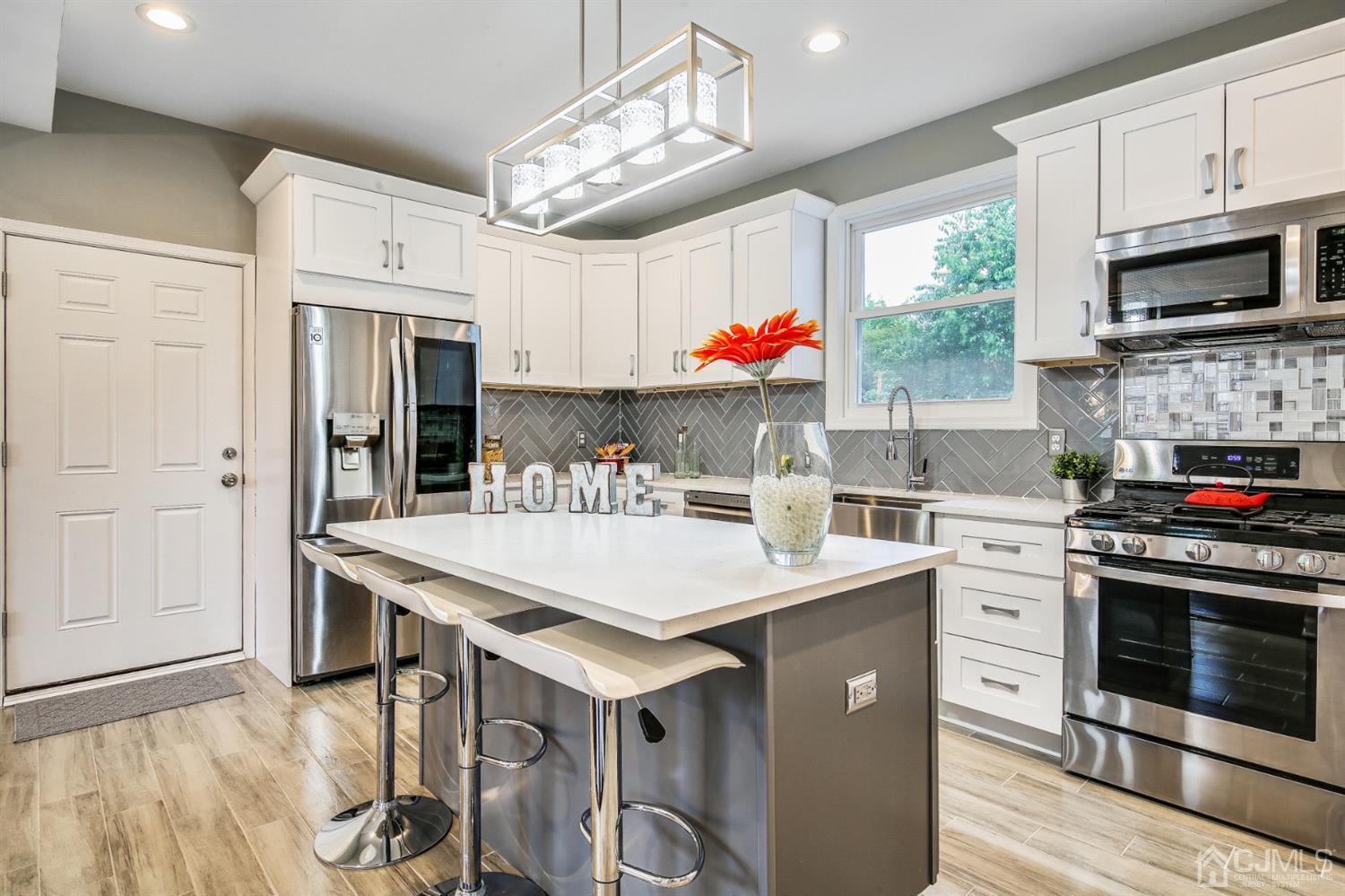 9 Markham Road Edison, NJ 08817 - Photo 8 of 28 a kitchen with stainless steel appliances a stove a sink and a refrigerator