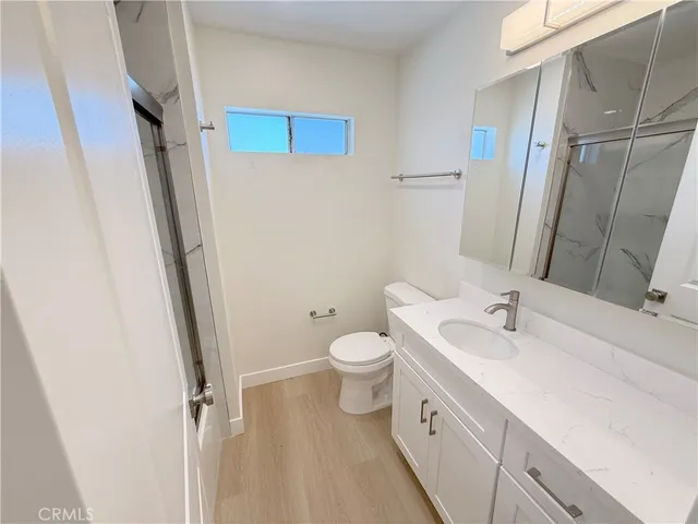 a bathroom with a double vanity sink toilet and shower